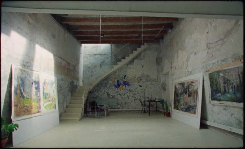Several pieces of art are displayed in a room