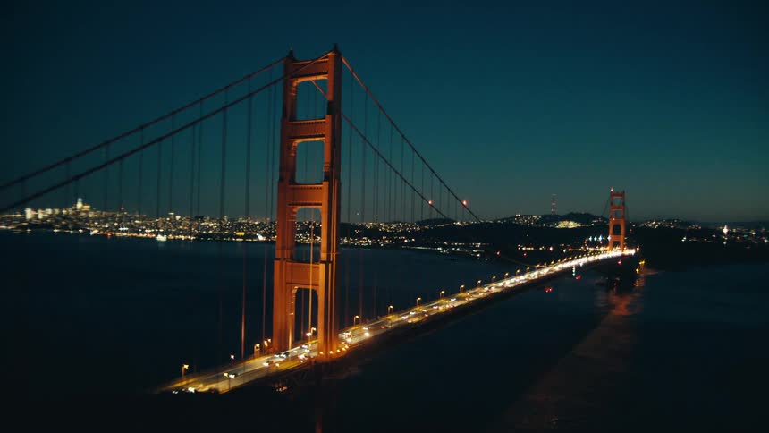 Commuters driving across golden gate bridge in san francisco at night
