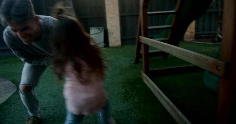 Father and daughter playing together in the backyard