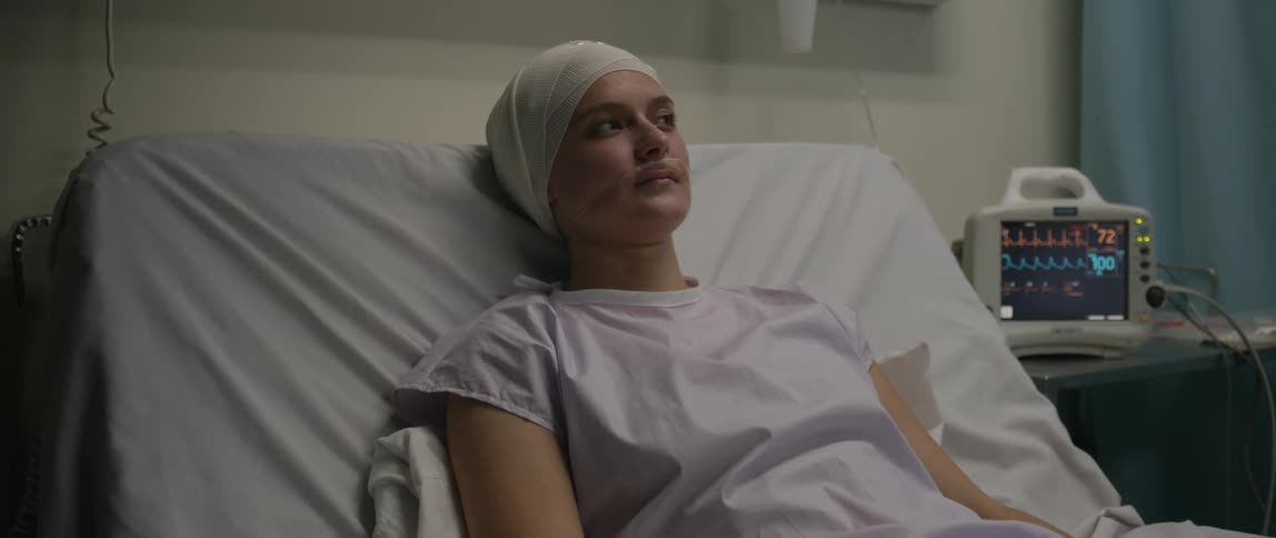 Female patient lying with equipment in a hospital room