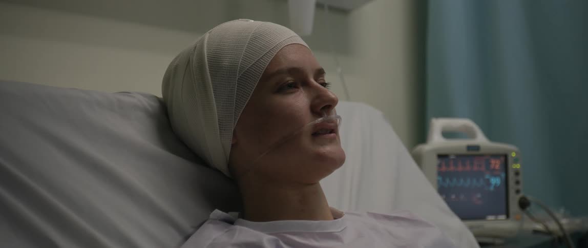 Woman admitted to a hospital room with an expression of pain