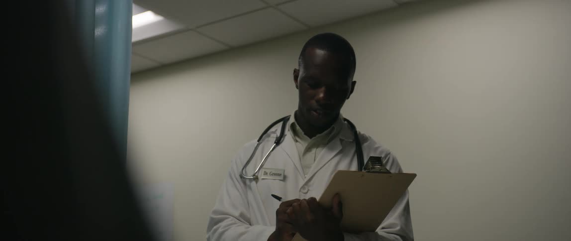A doctor writes notes on his clipboard