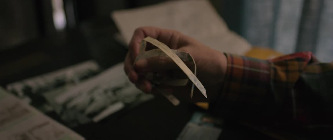 A man is holding a bracelet in the office