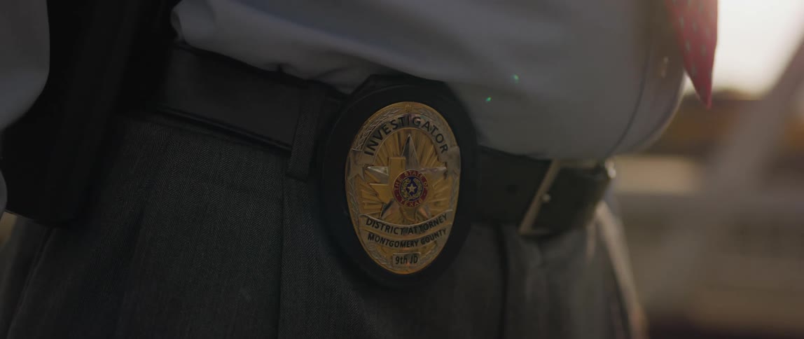 Police badge attached to a mans belt