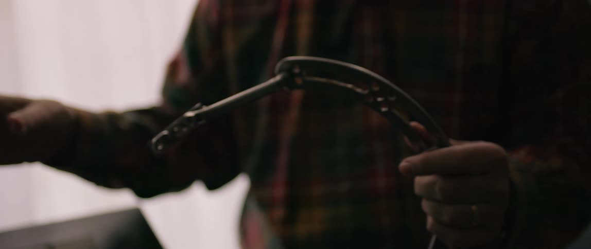 Pair of hands holding a metal object