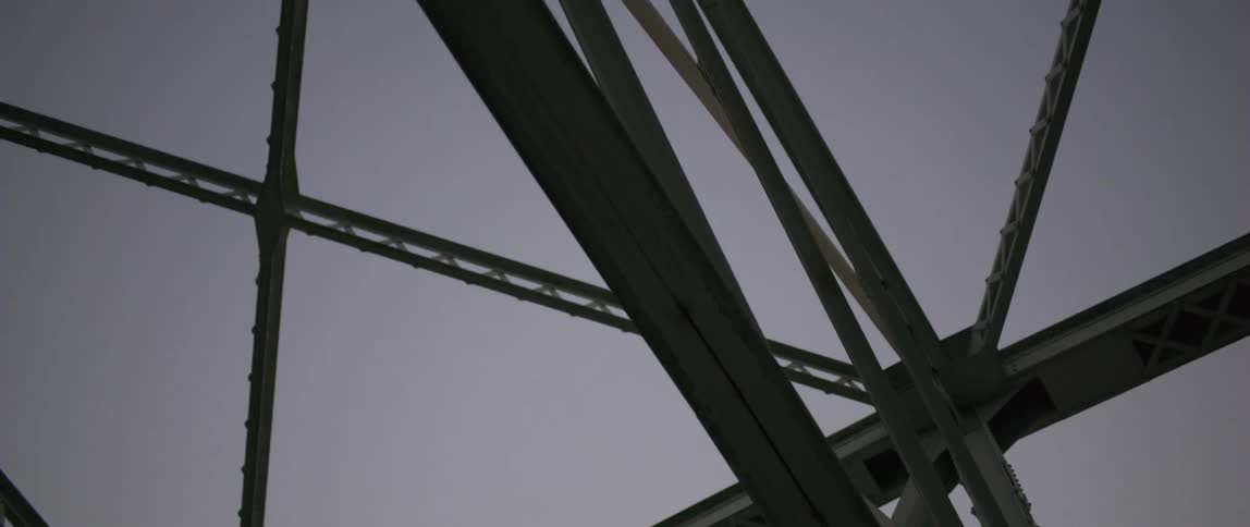 View of the metal structure of a bridge at sunset