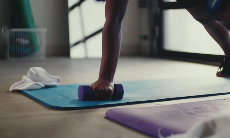 Two women are lifting weights together in a gym