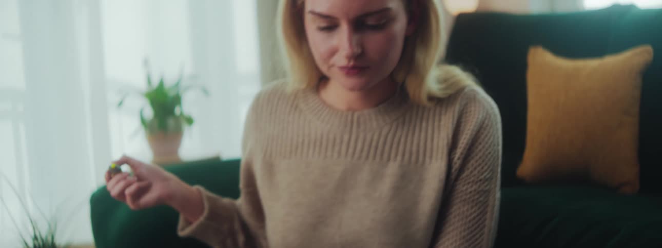 A woman sits and highlights a paper
