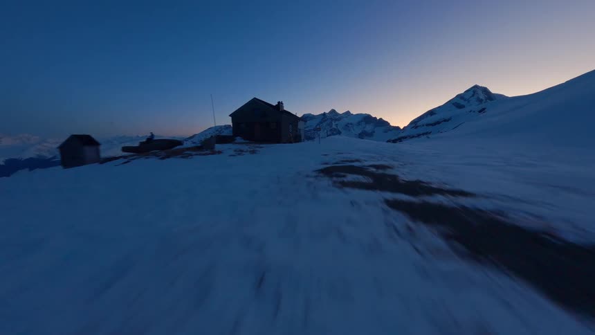 Isolated wooden house in the middle of a snowy mountain