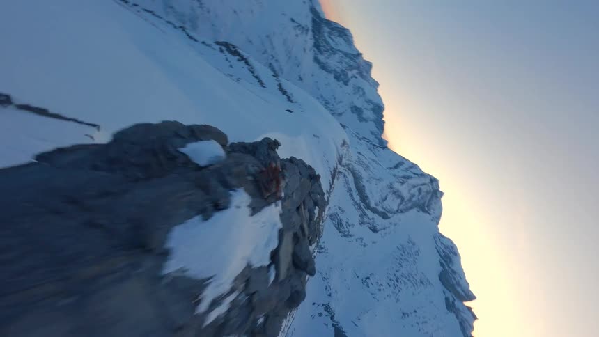 Drone Shot Over Snow-Capped Peaks Into a Majestic Swiss Valley