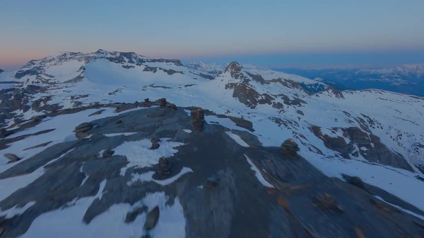 Aerials shot of a swiss mountain range covered with snow