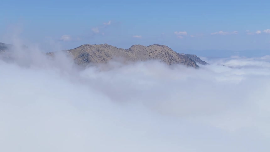 The mountain is taller than the white clouds