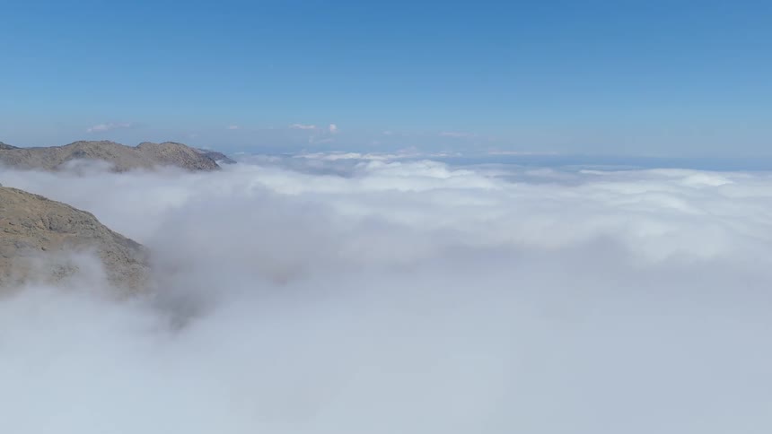 Aerial view of a sea of clouds and mountain peaks