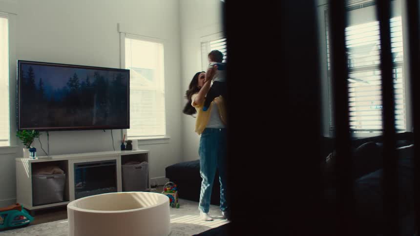 Mother in the living room playing with her son on her lap