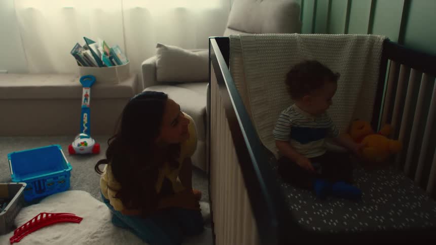 Mother playing peekaboo with her infant son