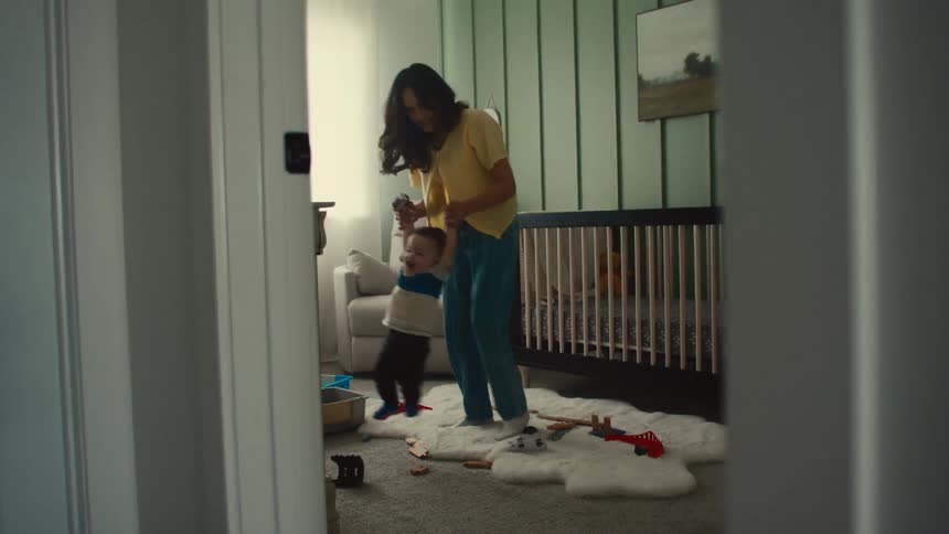Mother in the bedroom playing with her little son