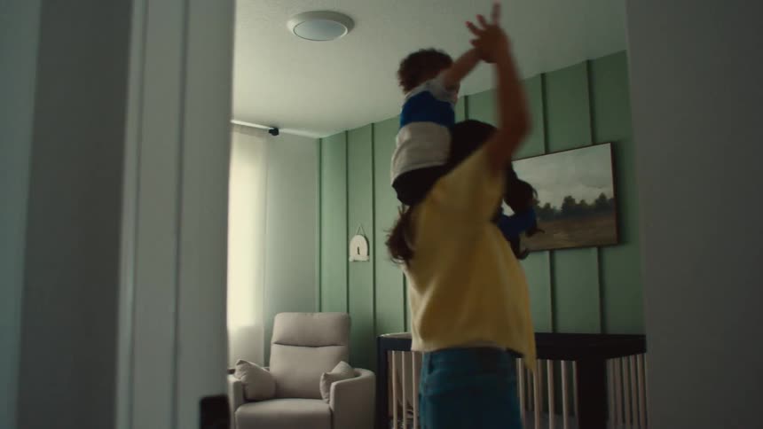 Mom dancing around in the nursery with her baby on her shoulders