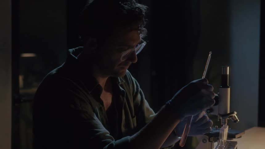 A man puts the test tube in the container