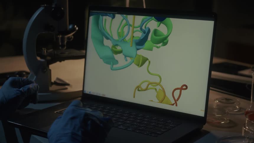 Pair of gloved hands in a lab interacting with a protein model