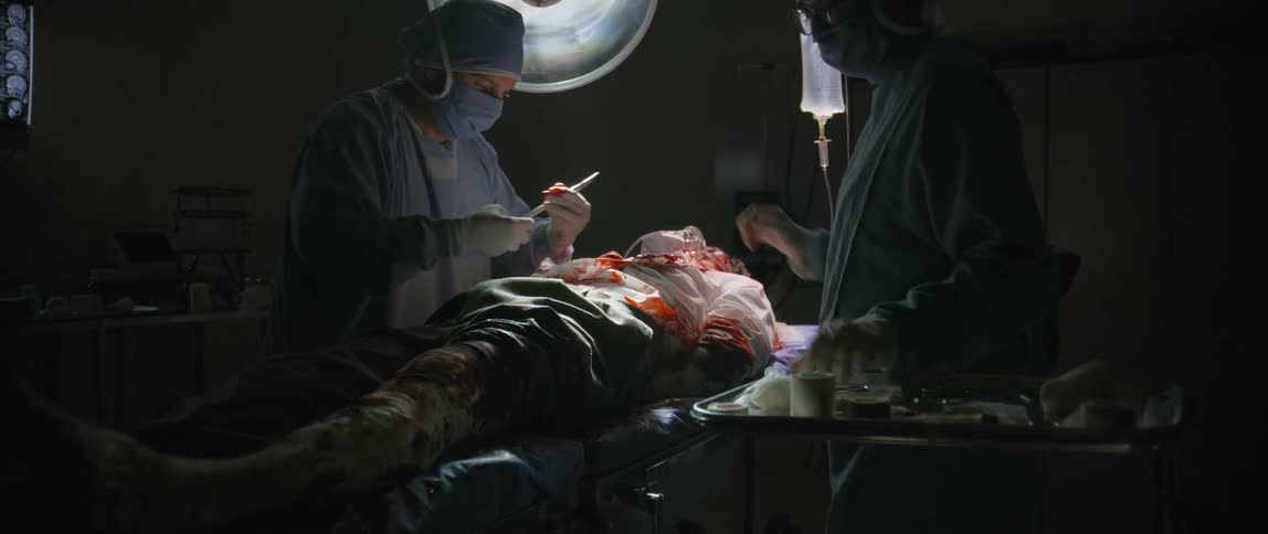 An injured man is receiving surgery in the operating room