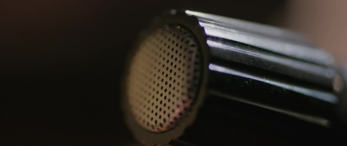 Close up vintage radio control knob with metal mesh cap
