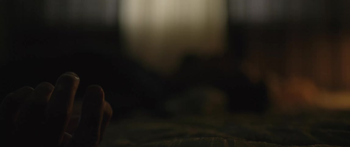 A person moves their hand in the dark room