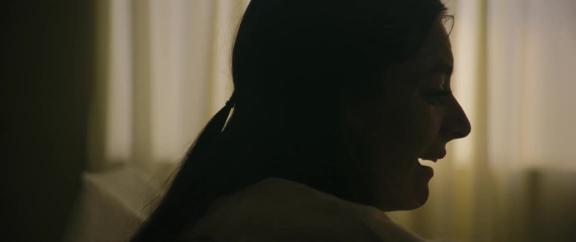 Silhouette profile of distressed woman crying in a hospital room