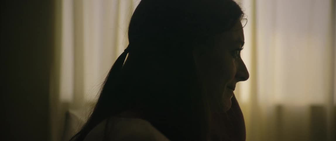 Silhouette profile of distressed woman crying in a hospital room