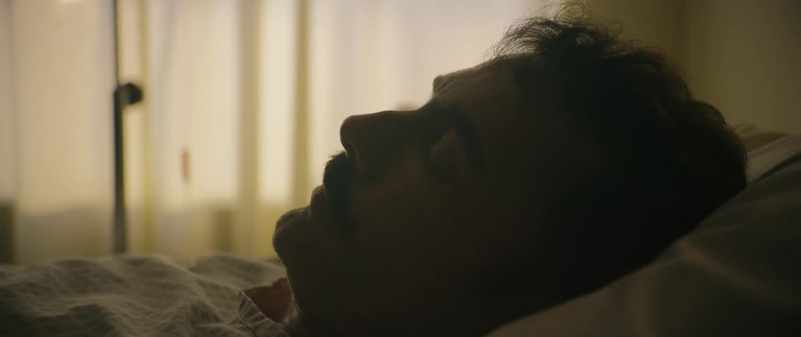 Sick man in a hospital room lying on a hospital bed