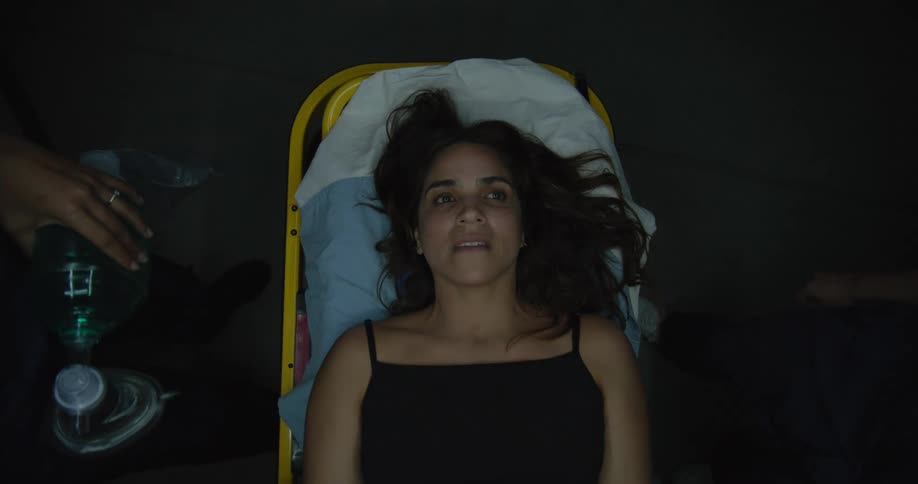 A woman is afraid on the emergency gurney