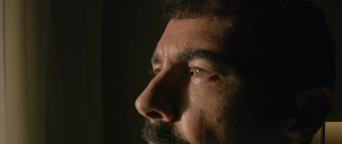 A man is sitting and blinking his eyes