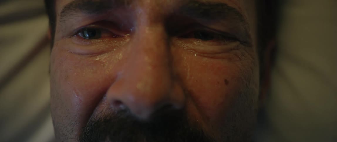 Portrait of a man with a sweaty face and a pained expression