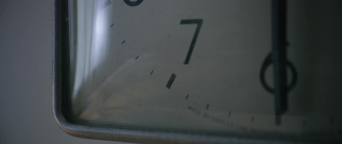 Movement in the room reflected in the glass cover of an analog clock