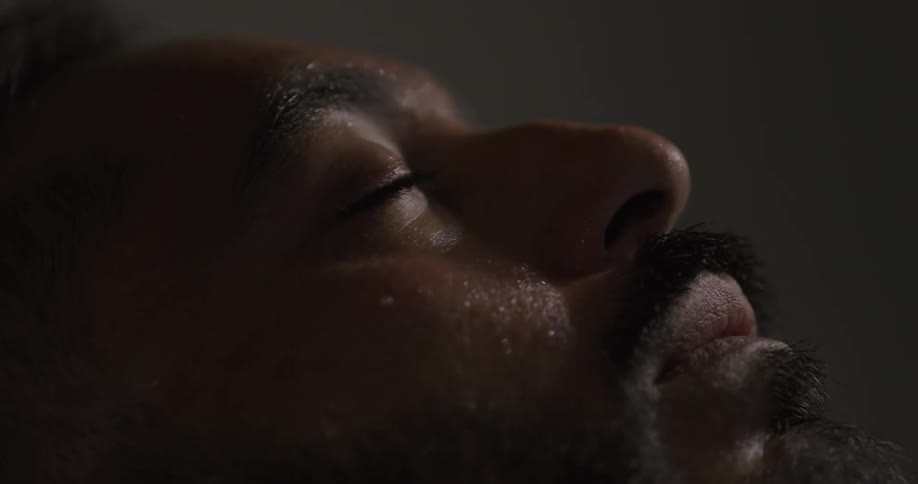 A sick man is sleeping shaking and sweating