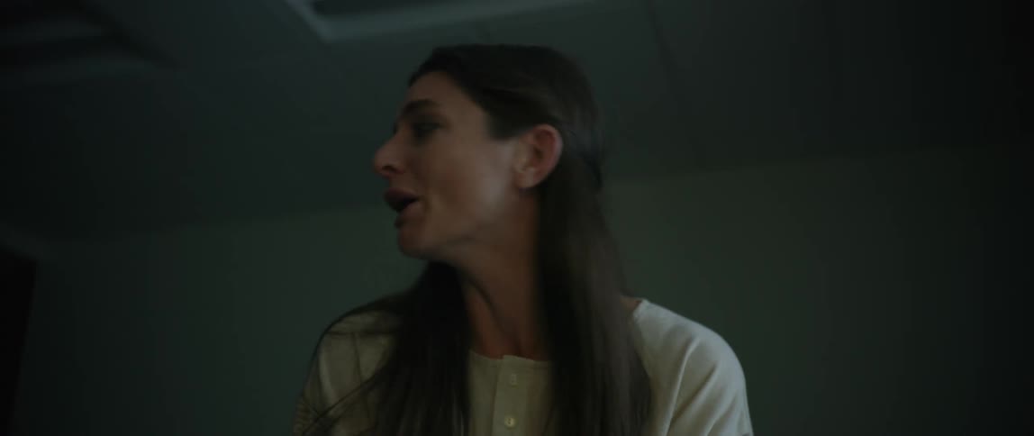 A woman is crying by a hospital bed