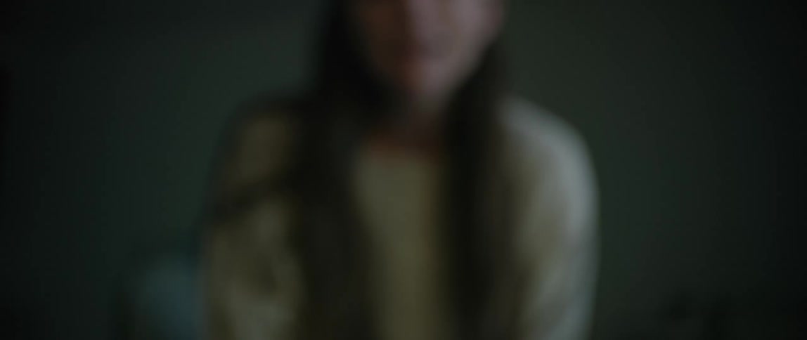 A woman crying in a dark room at night