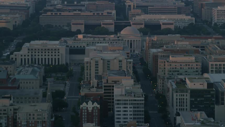 Tops of buildings and streets in city at sunset