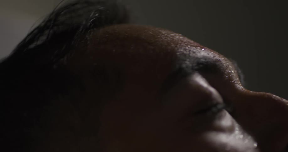 A man moves his head from side to side with his eyes closed
