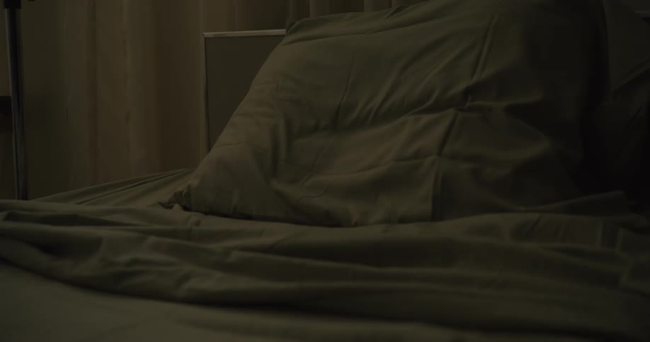 A bed is in a dimly lit room