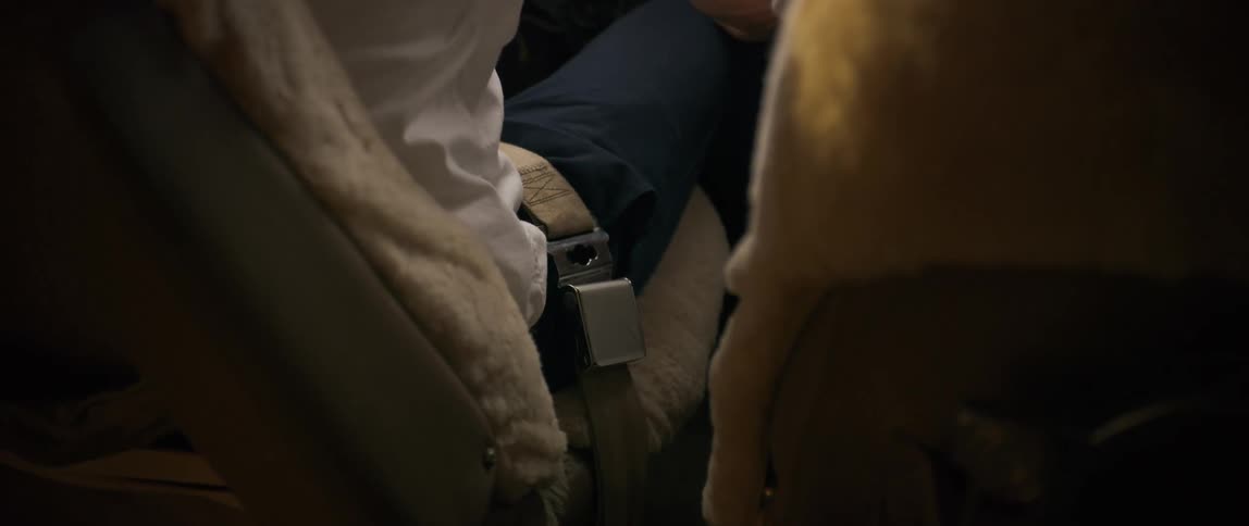 A pilot fastens his seat belt