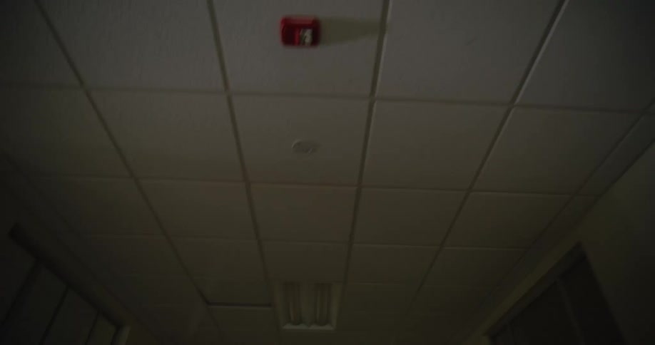 A ceiling with tiles is shown