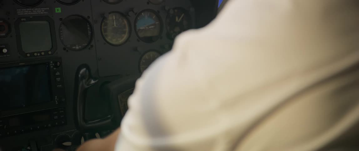 Pilot presses and turn buttons and knobs around the yoke at the cockpit