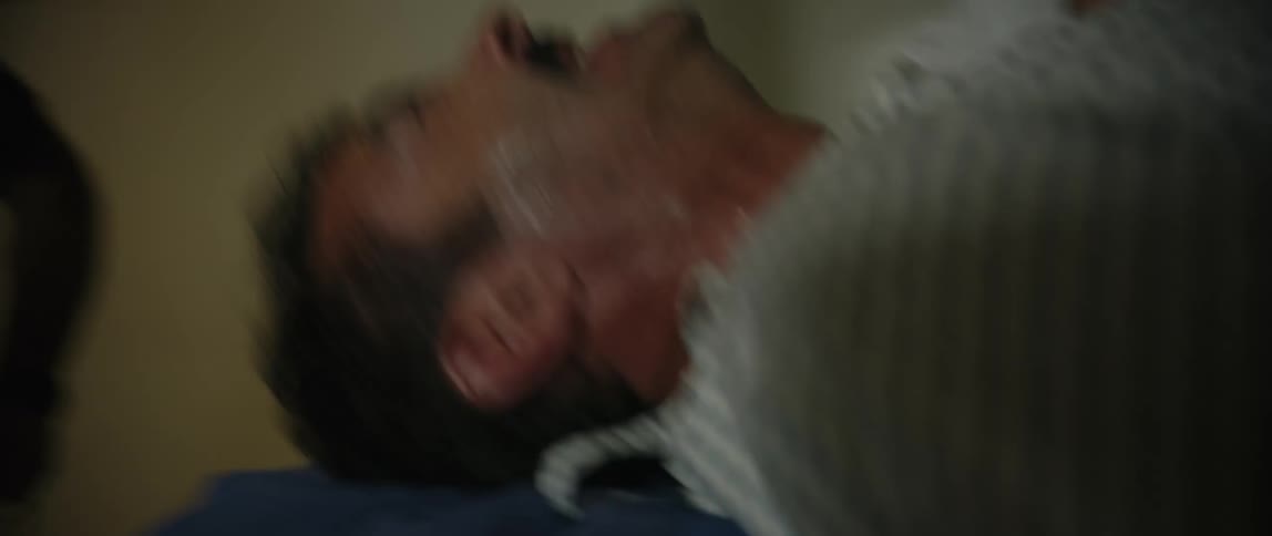 A patient is pushed on a gurney quickly though a hospital