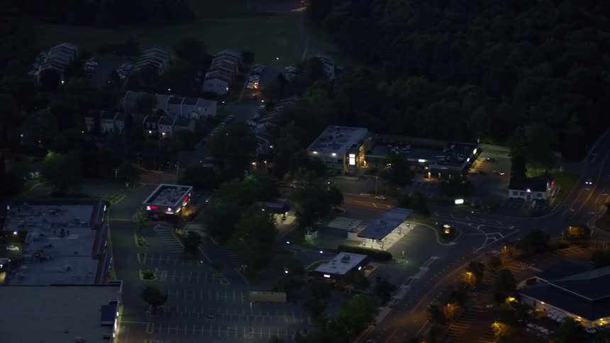 Street lights illuminate the night with buildings all around