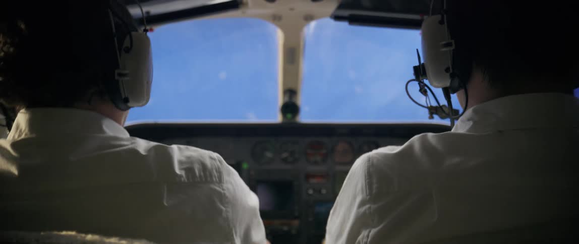 Pilot and copilot flying a plane moving forward during a crash