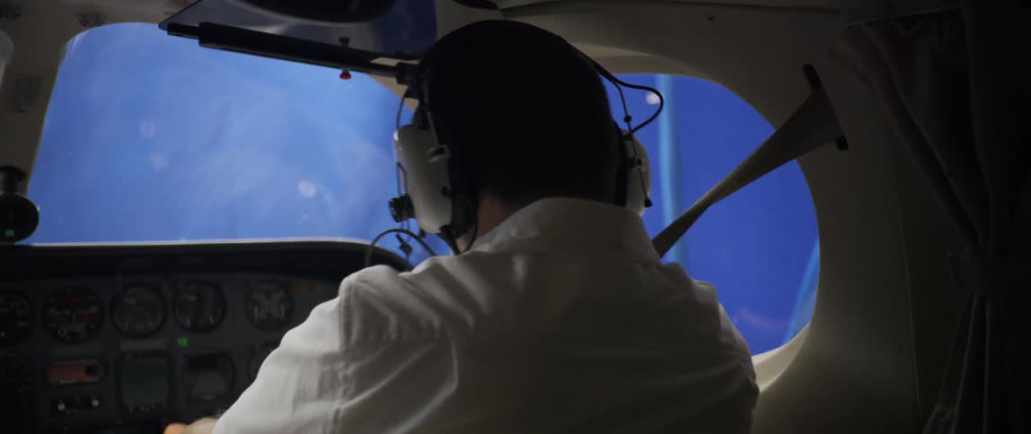 Male pilot steers an airplane as it shakes