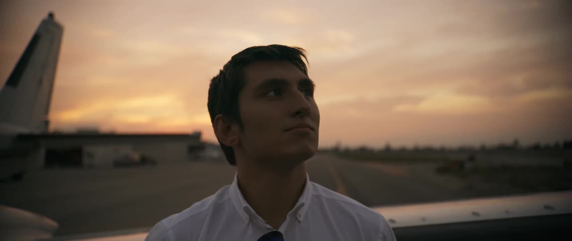 A man is standing near an airplane on the runway