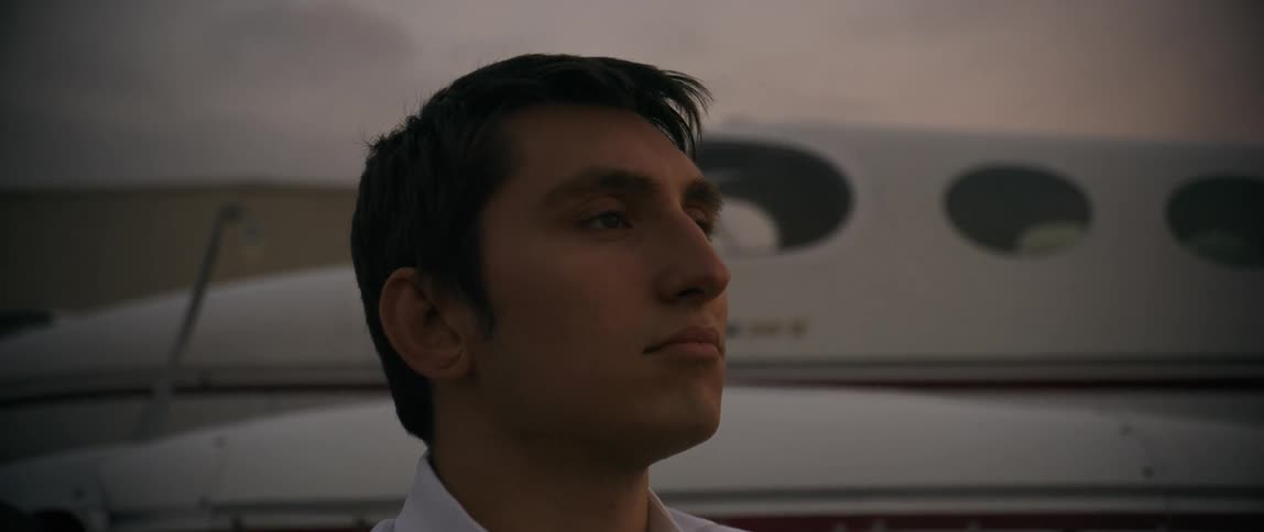 A footage of a pilot standing beside a private jet