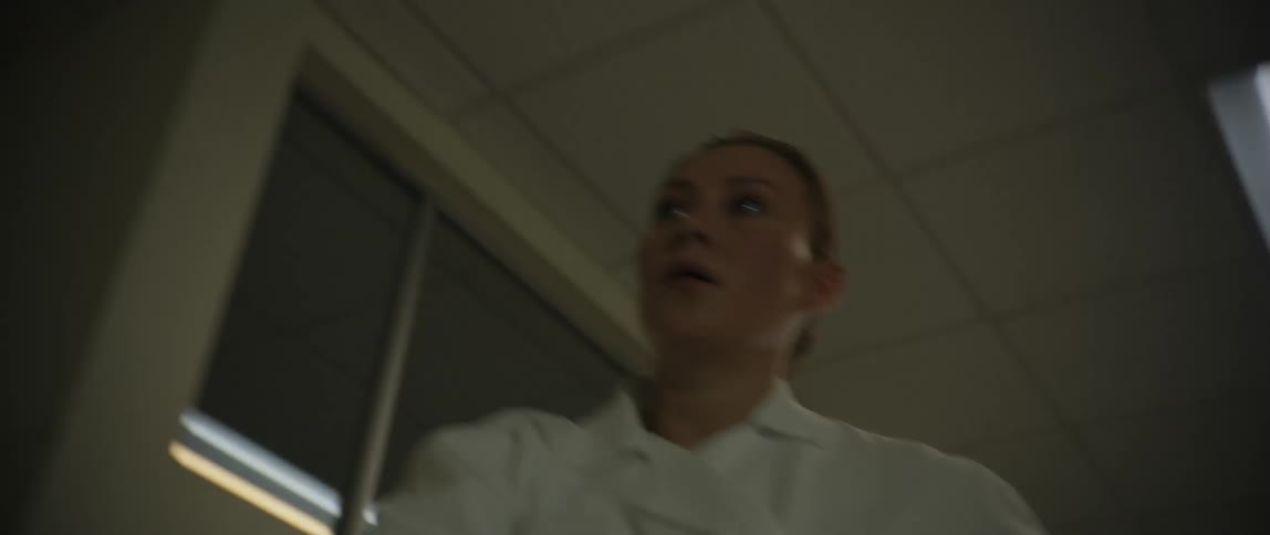 The nurse is running fast through the hospital hallway