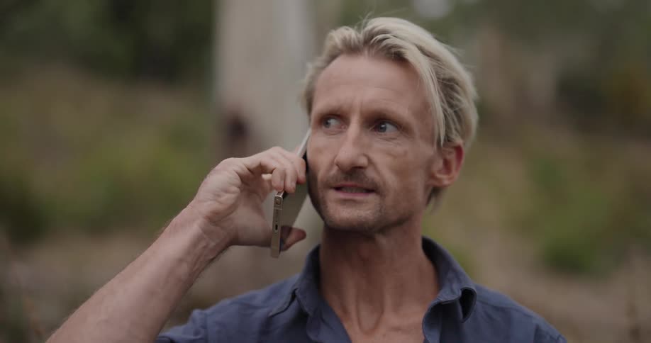 A man makes a phone call and ends it shortly after